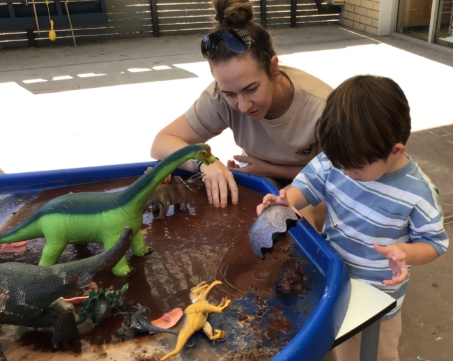 parent and child doing messy play dinosaur activity